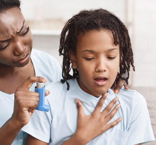 Mother handing an inhaler to her coughing daughter